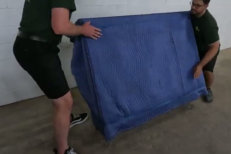 Carrying a wrapped mattress out